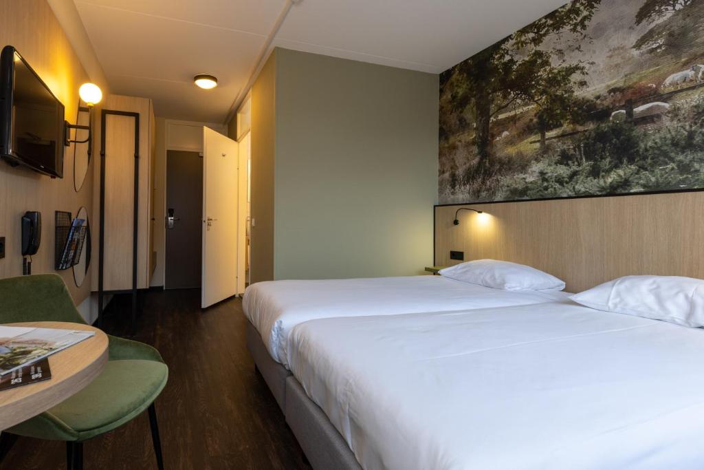 Postel nebo postele na pokoji v ubytování Fletcher Hotel-Restaurant Frerikshof