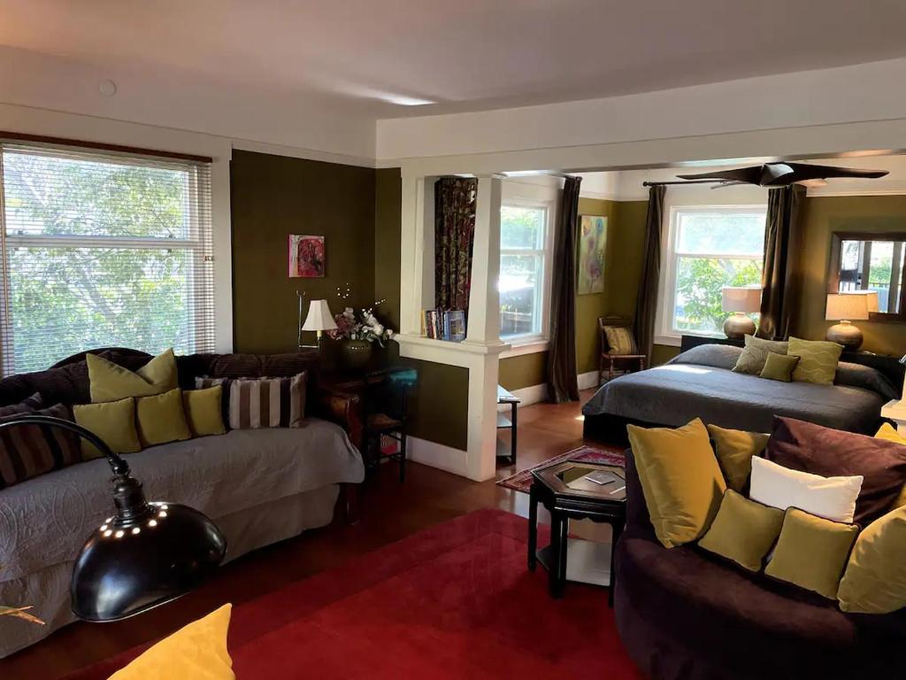 a living room with a couch and a bed at The 3 Dux in Santa Barbara