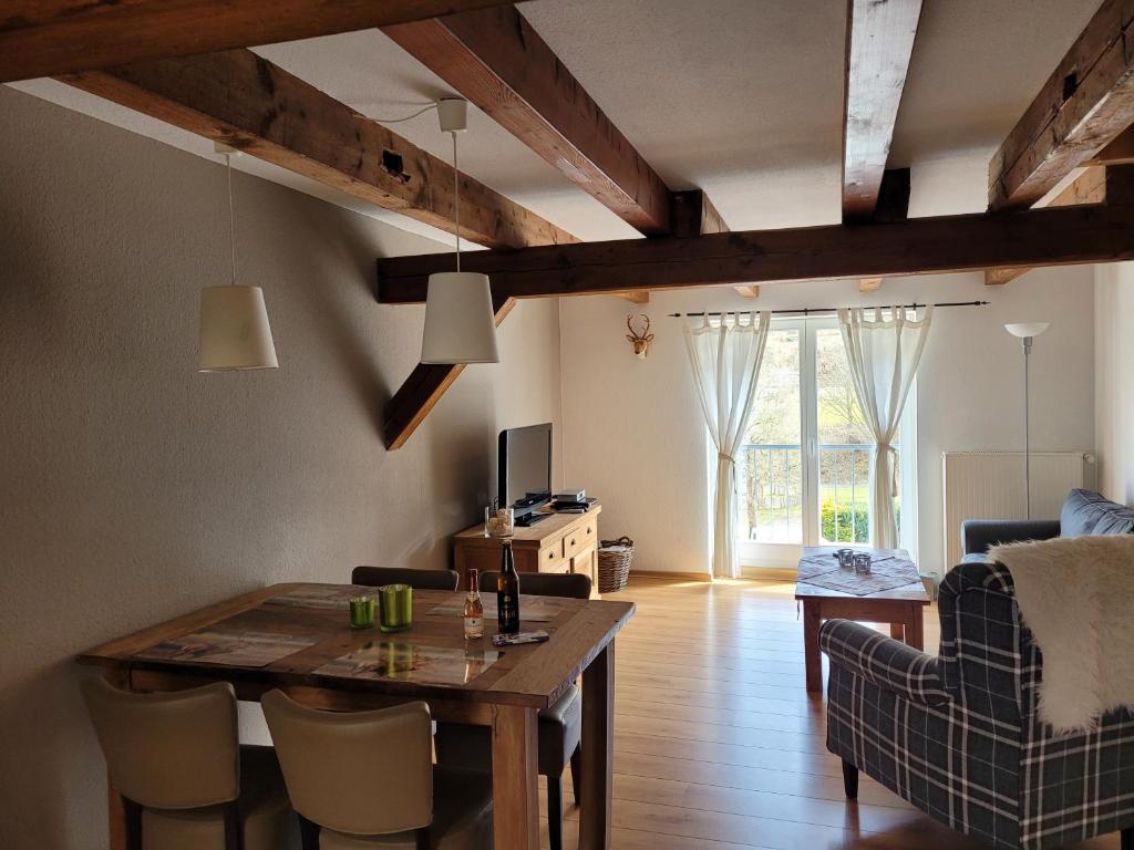sala de estar con mesa de madera y comedor en Ferienwohnung Forsthaus, en Willingen