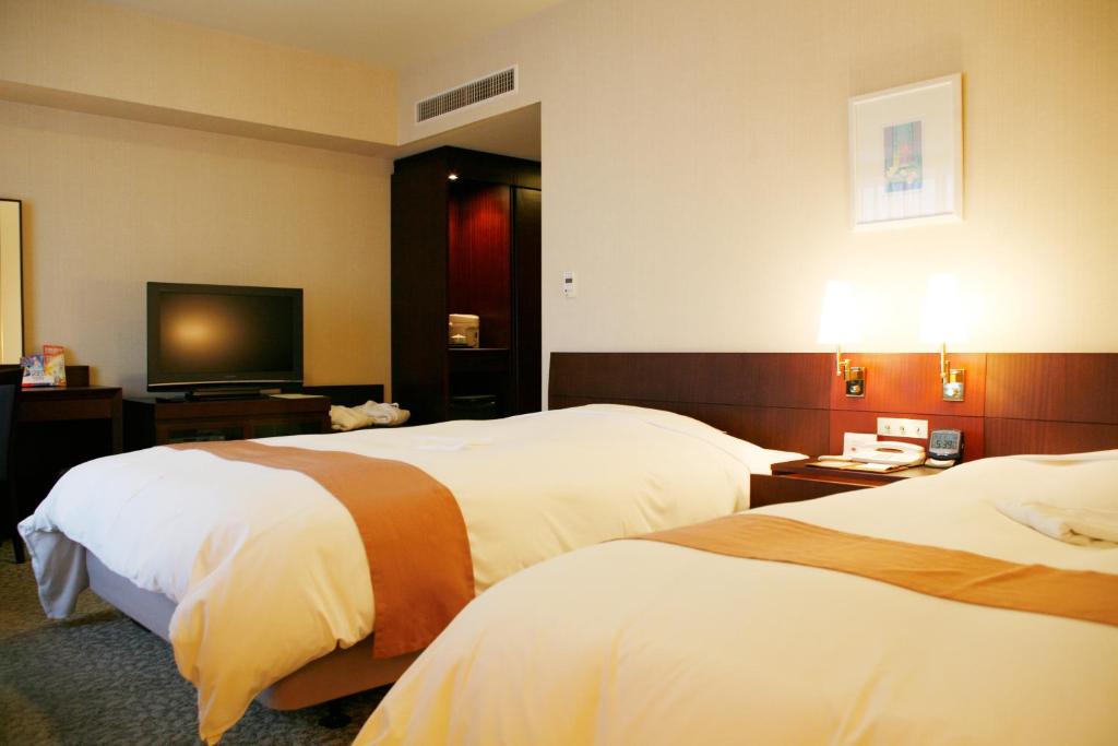 Postel nebo postele na pokoji v ubytování Keisei Hotel Miramare