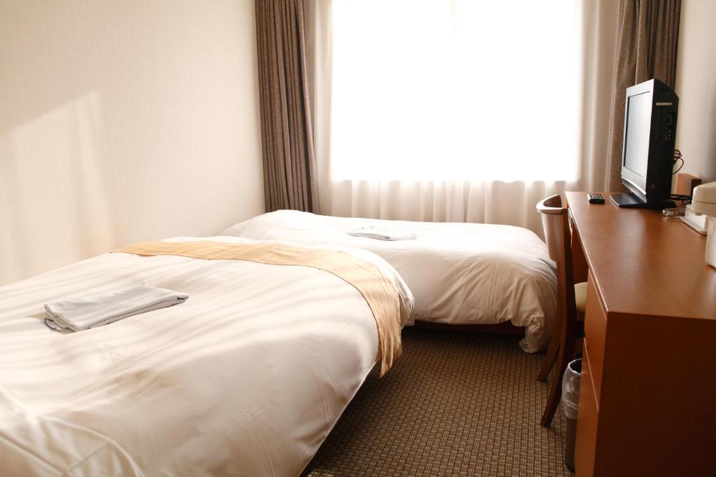 Postel nebo postele na pokoji v ubytování Keisei Hotel Miramare