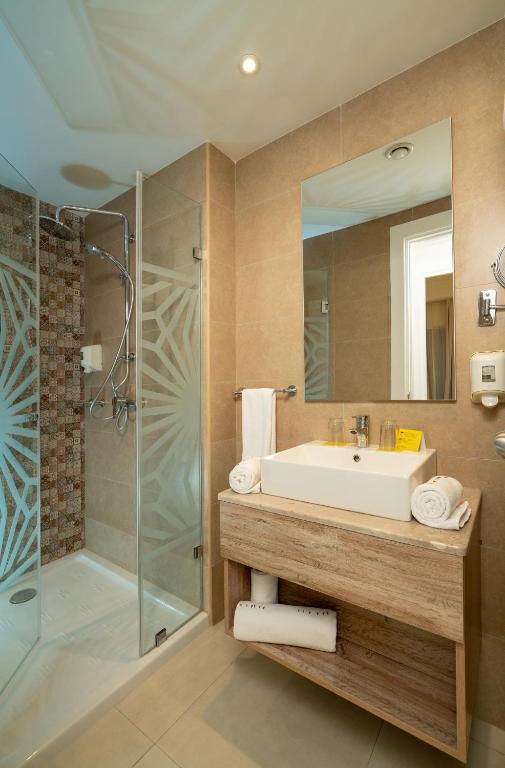a bathroom with a sink and a shower at TUI MAGIC LIFE Penelope Beach - Families & Couples in Midoun