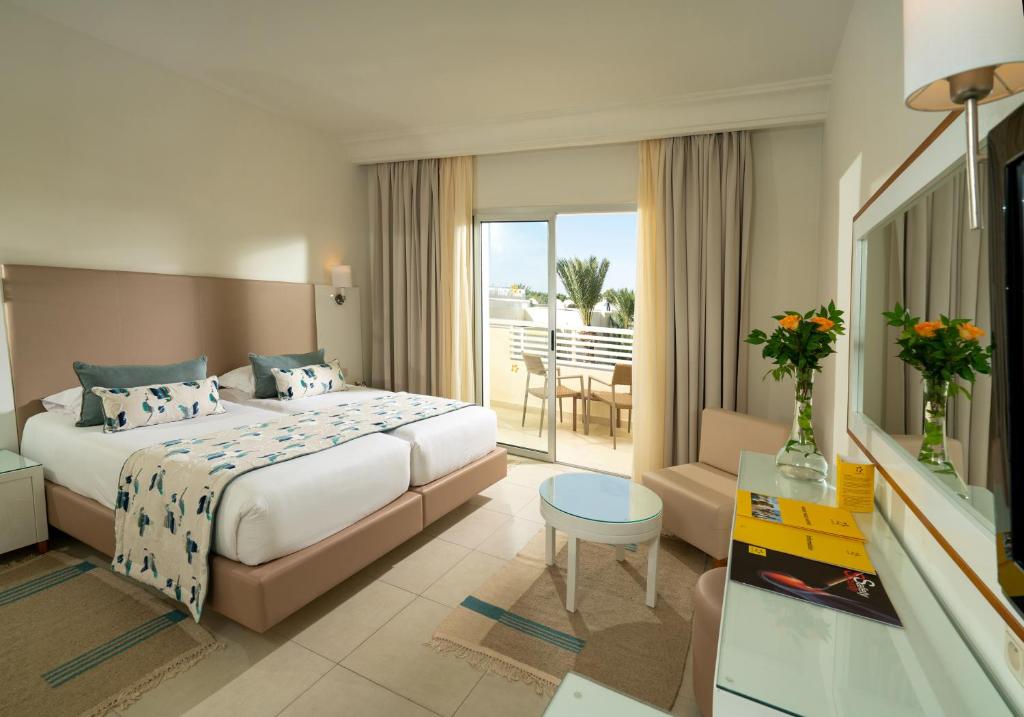 a hotel room with a bed and a balcony at TUI MAGIC LIFE Penelope Beach - Families & Couples in Midoun