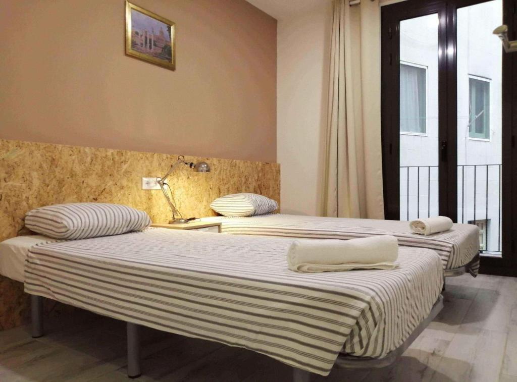 Posteľ alebo postele v izbe v ubytovaní Diagonal Apartments