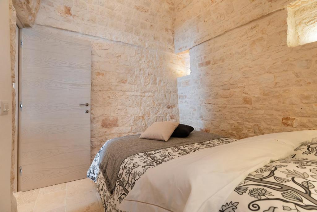 Posteľ alebo postele v izbe v ubytovaní Suite21 - The Trulli Experience