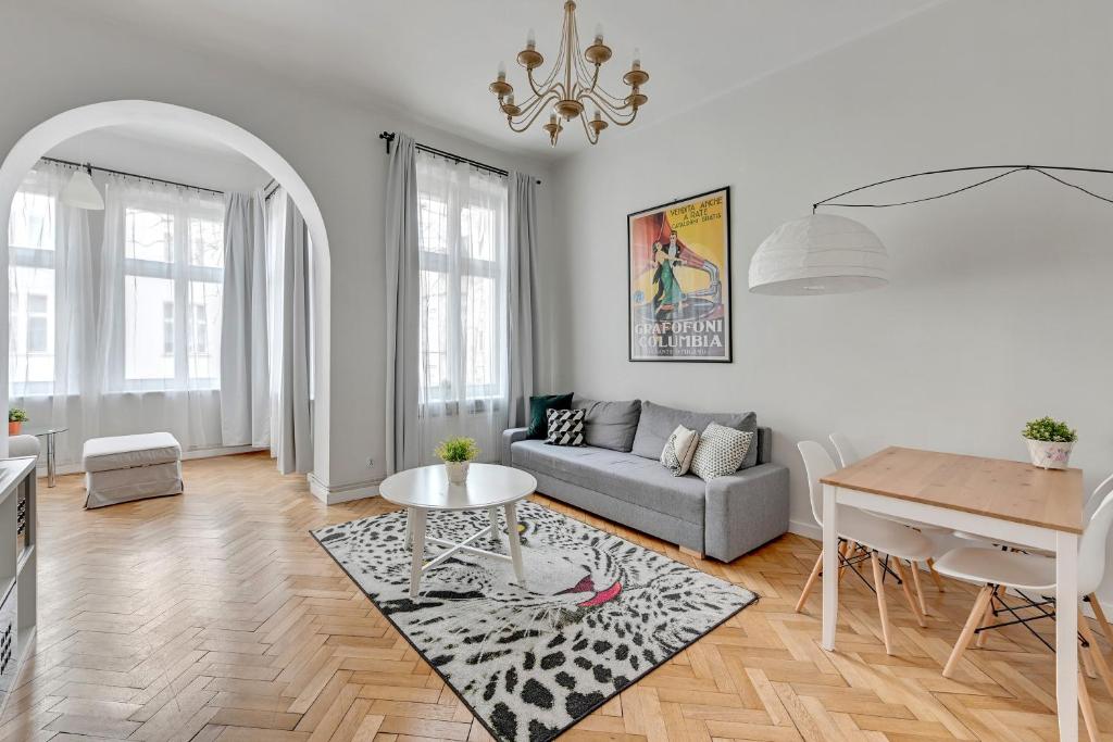 a living room with a couch and a table at Atelier Apartment Centrum by Grand Apartments in Sopot