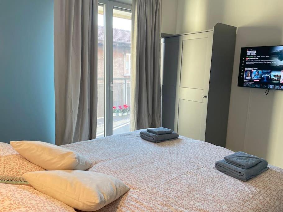 1 dormitorio con 1 cama grande y 2 toallas. en CITY CENTER - Modern flat with FREE PARKING and WIFI - Apt A, en Bérgamo