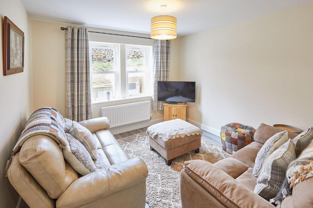 a living room with two couches and a television at Host & Stay - Carlewell Cottage in Middlesmoor