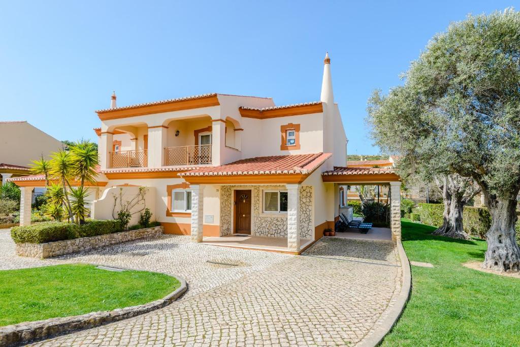 a villa with a courtyard and a church at Casa Sunny Days - Boavista Resort in Lagos