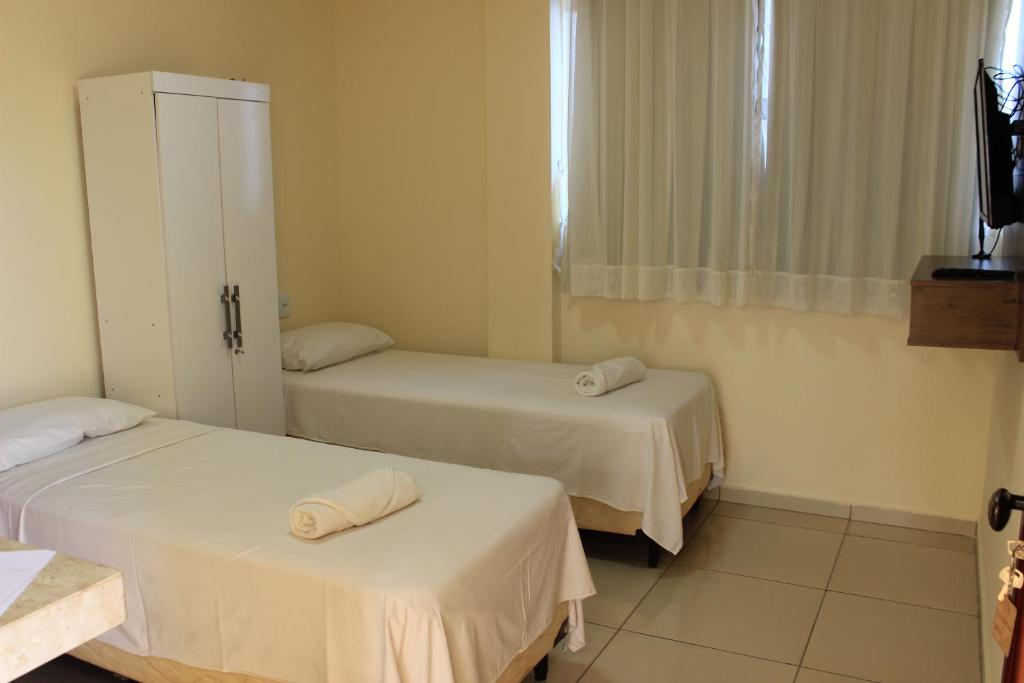 A bed or beds in a room at Pousada Carnaúbas