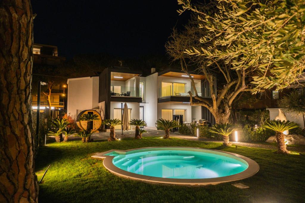 a pool in front of a house at night at Luxury B&B La Riserva Dannunziana in Pescara