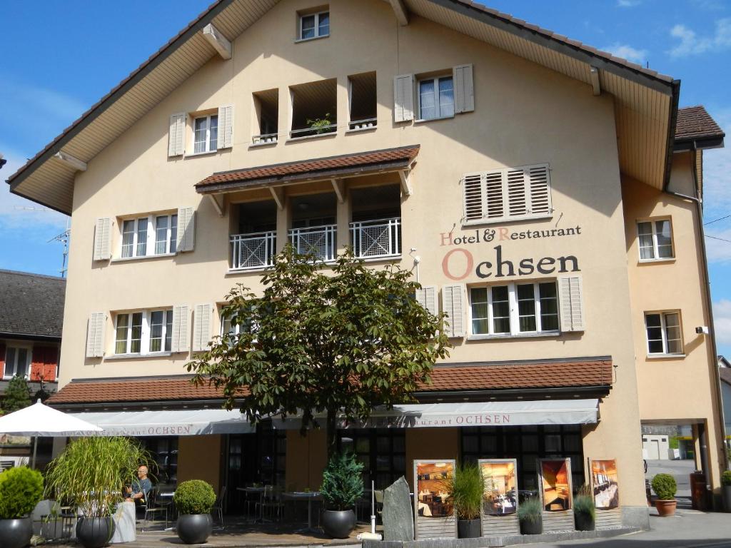 ein großes Gebäude mit einem Schild, das oliver liest in der Unterkunft Hotel Ochsen in Menzingen