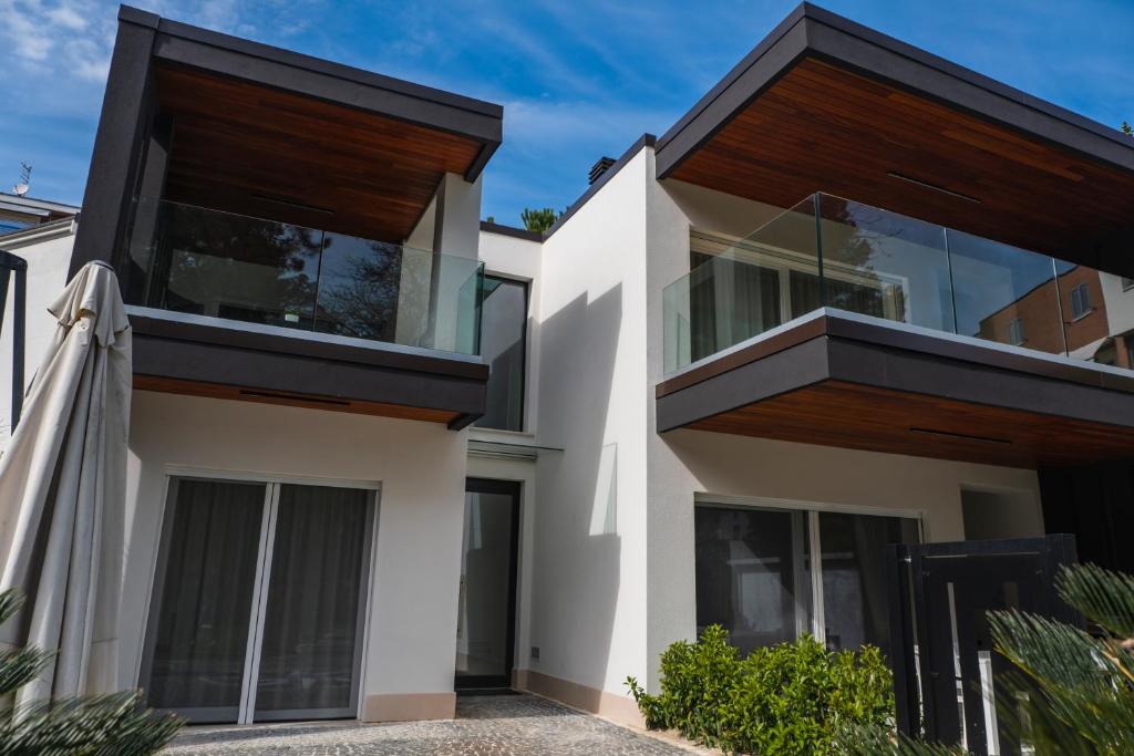 a house with white walls and wooden balconies at Luxury B&B La Riserva Dannunziana in Pescara