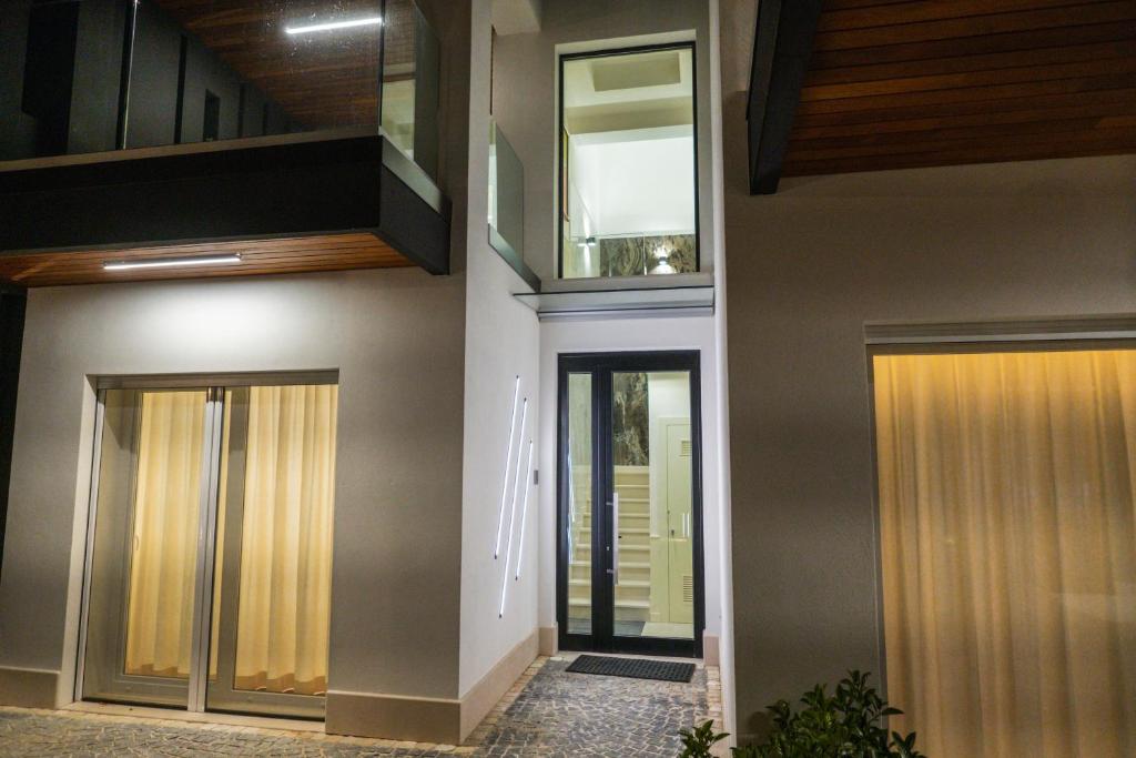 a hallway leading to a house with glass doors at Luxury B&B La Riserva Dannunziana in Pescara