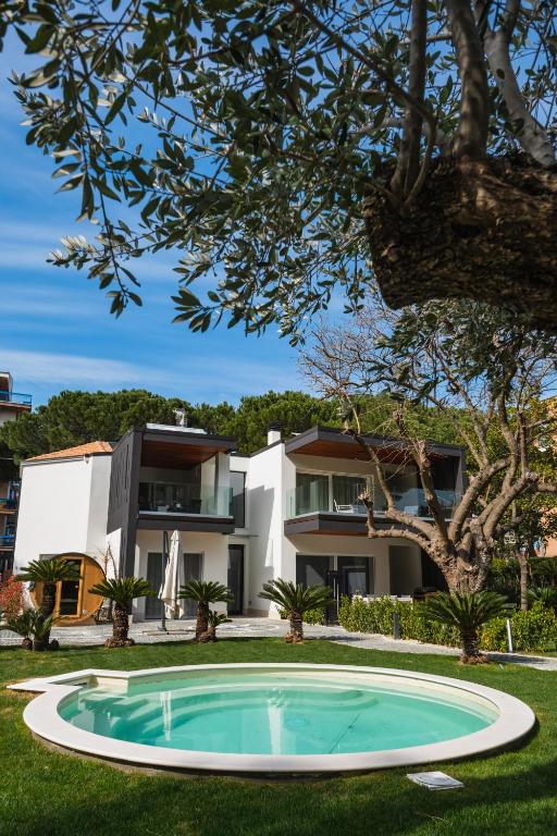 a swimming pool in front of a house at Luxury B&B La Riserva Dannunziana in Pescara