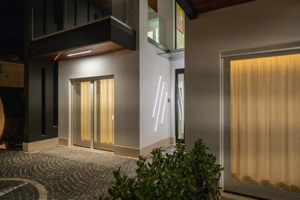 a hallway with doors and plants in a building at Luxury B&B La Riserva Dannunziana in Pescara