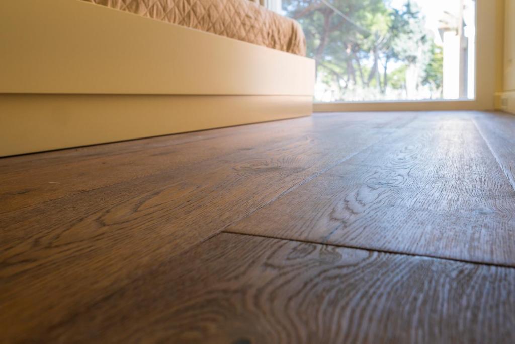 an empty room with a wooden floor and a window at Luxury B&B La Riserva Dannunziana in Pescara