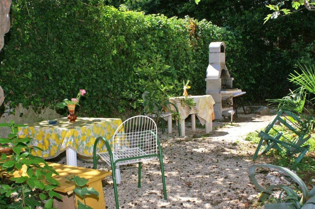 a garden with a table and chairs and a table with flowers at Apartment Brane - great location & garden terrace in Split