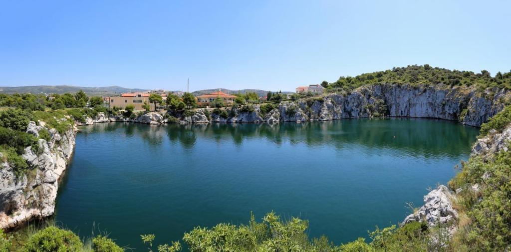 a large pool of water in the middle of a mountain at Apartments Lias - with restaurant in Rogoznica