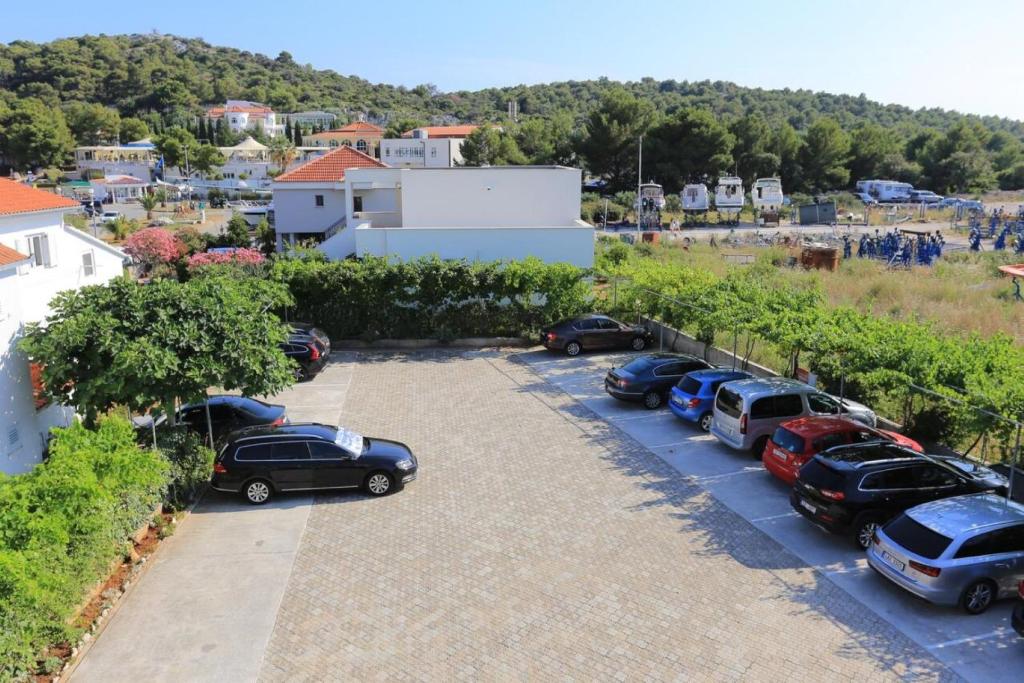 a row of cars parked in a parking lot at Apartments Lias - with restaurant in Rogoznica