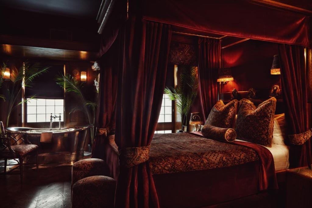 a hotel room with a large bed and a large window at House of Gods Royal Mile in Edinburgh