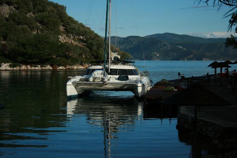 a boat is docked in a body of water at On Y Va , Delightful 3 bedroom catarmaran, with skipper in Marmaris