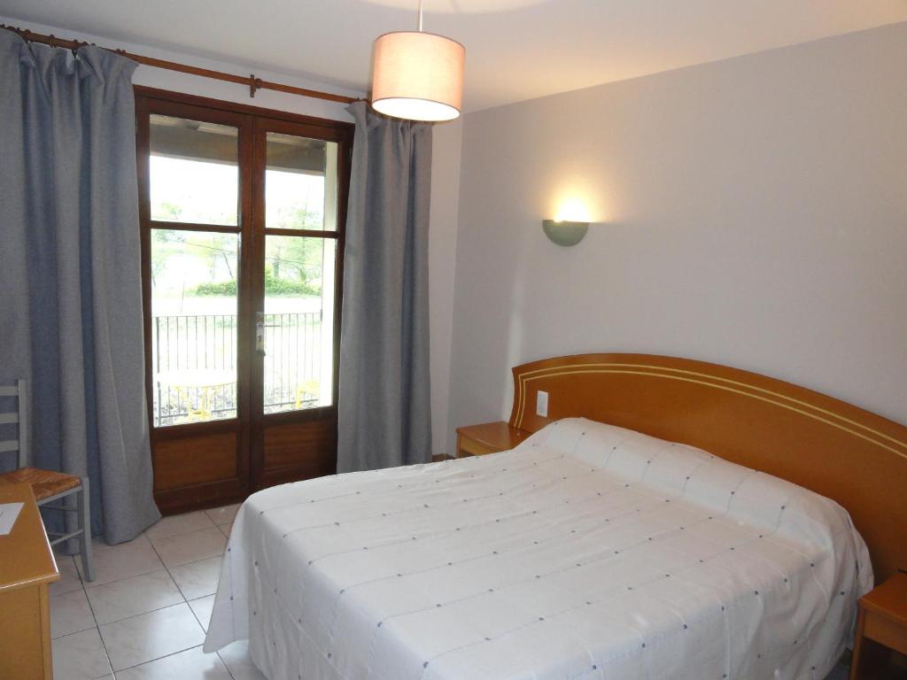 Postel nebo postele na pokoji v ubytování Hotel de l'île