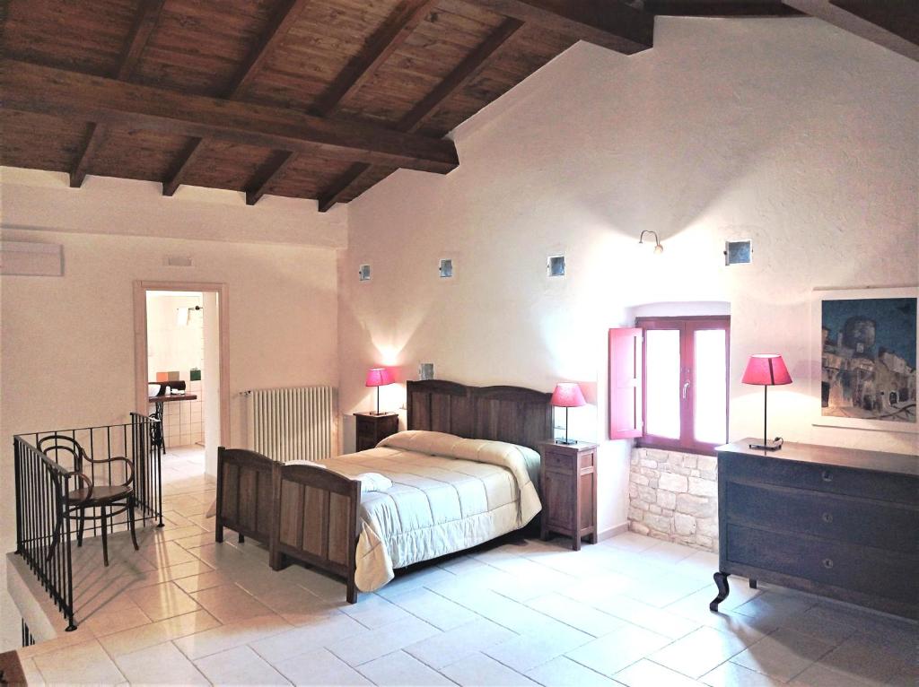 a bedroom with a bed and a table and chairs at Case Vacanza Al Borgo Antico in Vico del Gargano