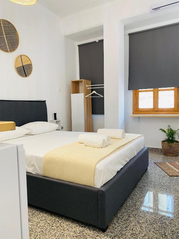 a bedroom with two beds in a room at Homdwell Fine Living 2 in Ermoupoli