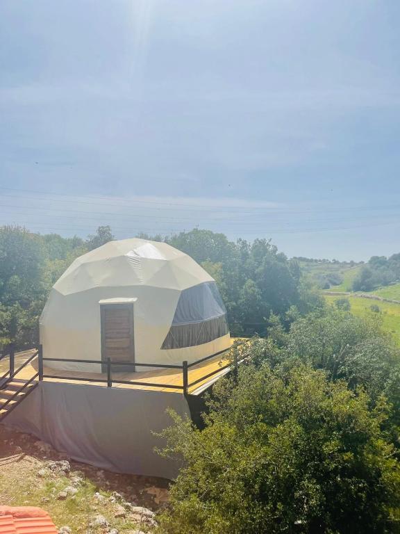 a large white dome tent on top of a field at ببالز Ajloun عش وسط الطبيعة - ِAjloun Bubbles Live amid nature in Ajloun