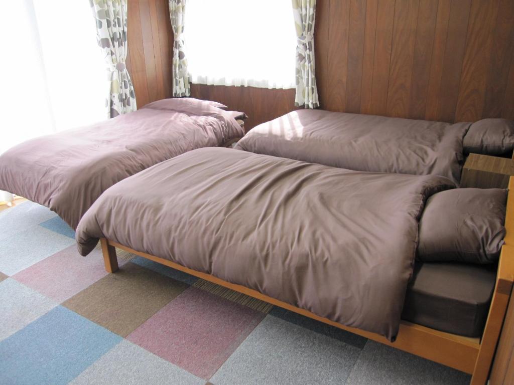 Postel nebo postele na pokoji v ubytování ゲストハウス あずも GuestHouse AZMO