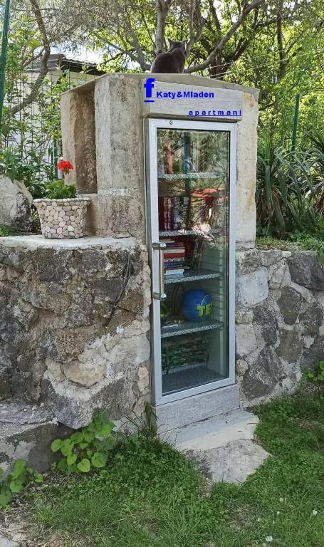 a cat sitting on top of a phone booth at KATY&MLADEN in Baška