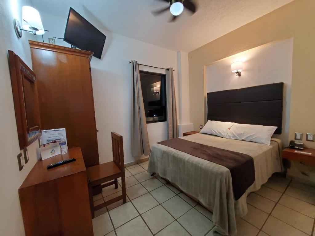 Postel nebo postele na pokoji v ubytování Hotel El Relicario
