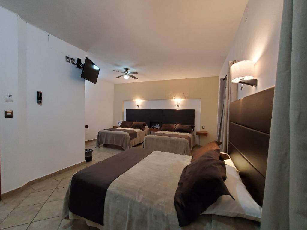 Postel nebo postele na pokoji v ubytování Hotel El Relicario