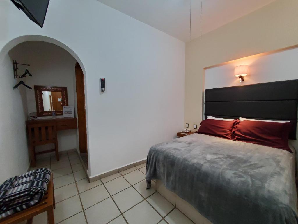 Postel nebo postele na pokoji v ubytování Hotel El Relicario