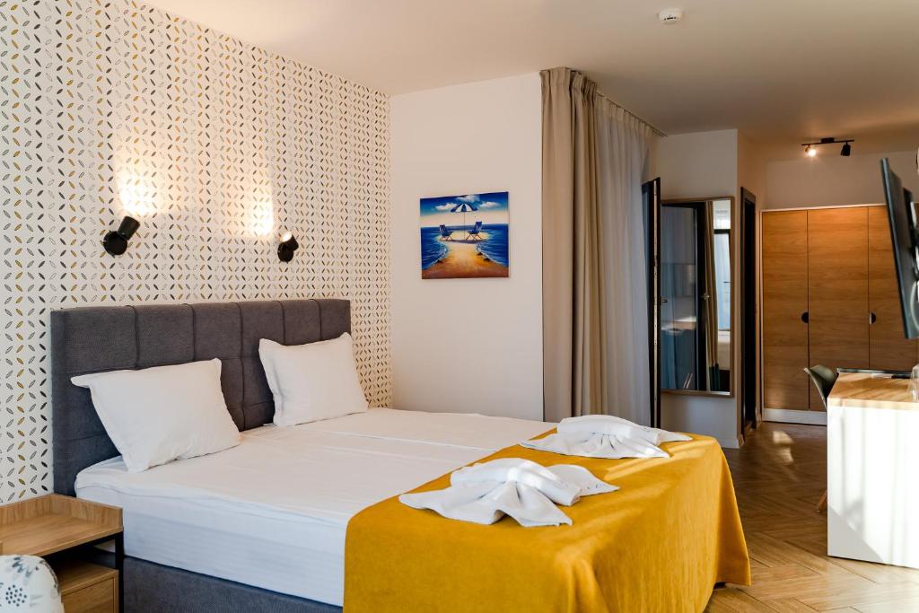 Postel nebo postele na pokoji v ubytování Family Hotel LAXO