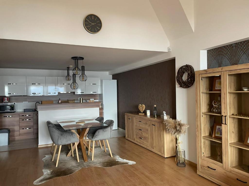 a kitchen and dining room with a table and chairs at Apartman_donovaly_residence in Donovaly