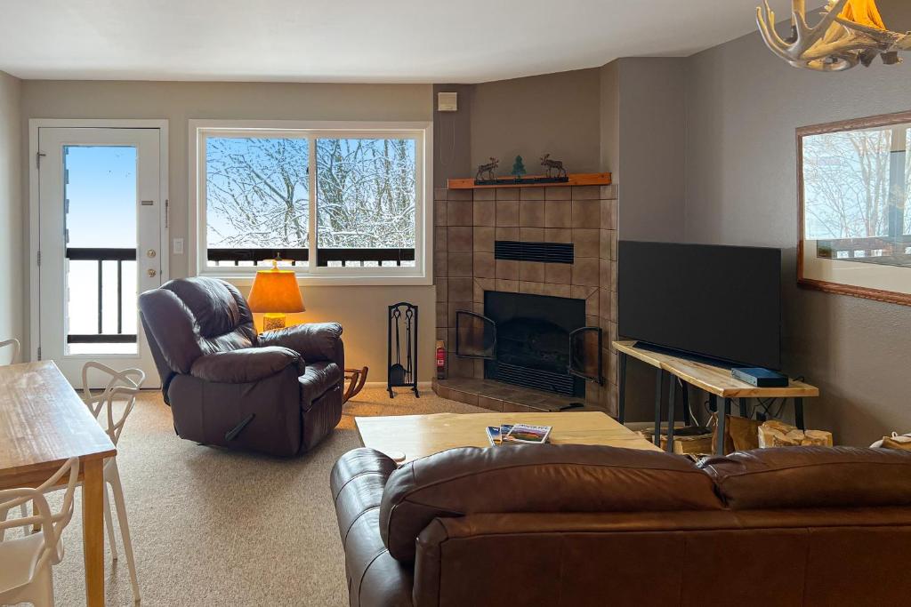 a living room with two couches and a fireplace at 2404 Pitchfork in Jackson