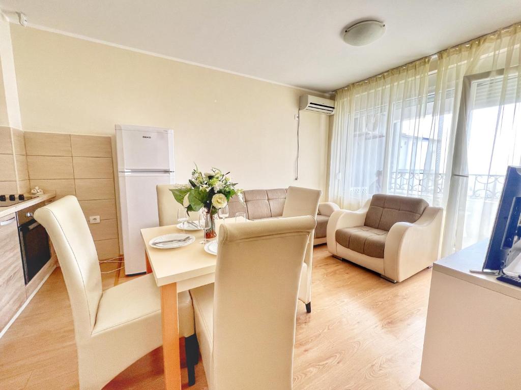 a kitchen and living room with a table and chairs at Adriatique Apartments in Dobra Voda