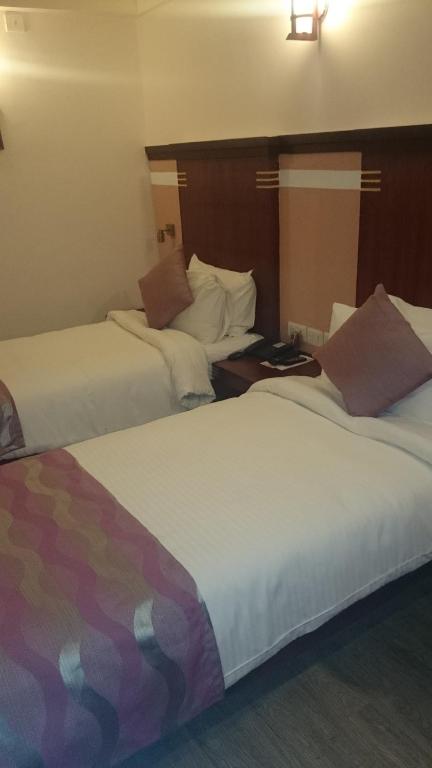 Postel nebo postele na pokoji v ubytování Rain Drops Hotel