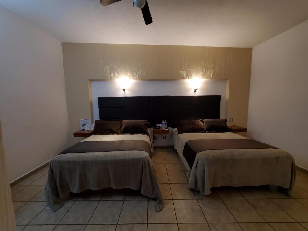Postel nebo postele na pokoji v ubytování Hotel El Relicario