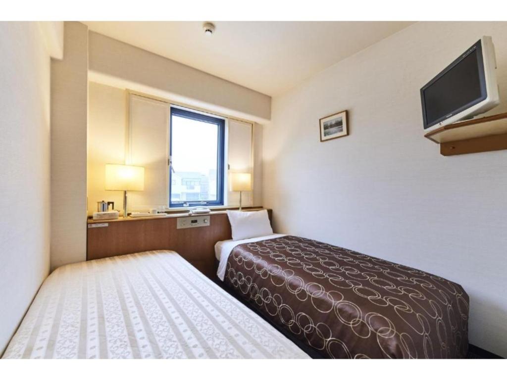Giường trong phòng chung tại Urayasu Sun Hotel - Vacation STAY 33023v