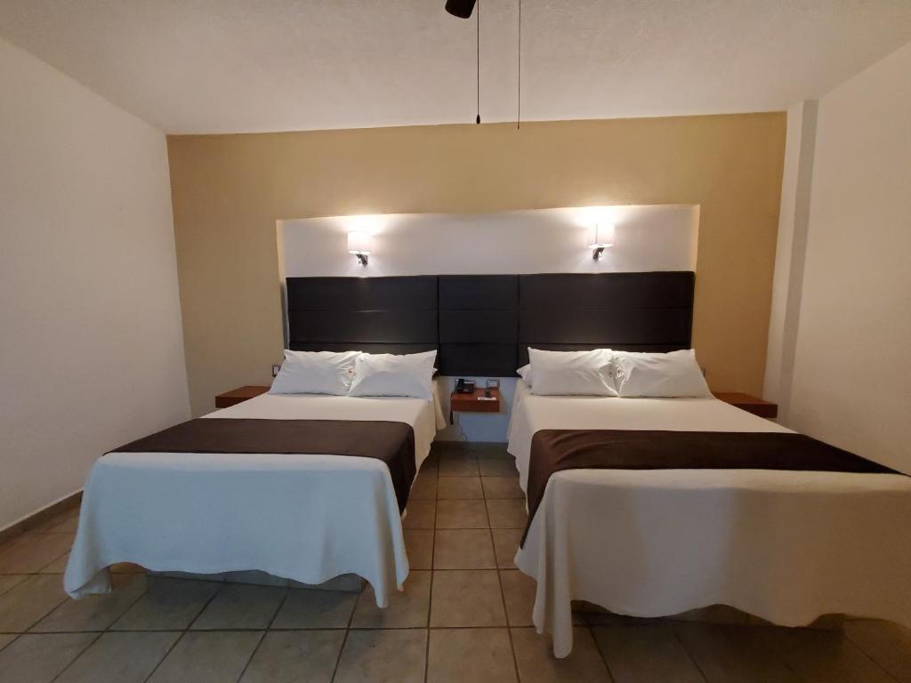 Postel nebo postele na pokoji v ubytování Hotel El Relicario