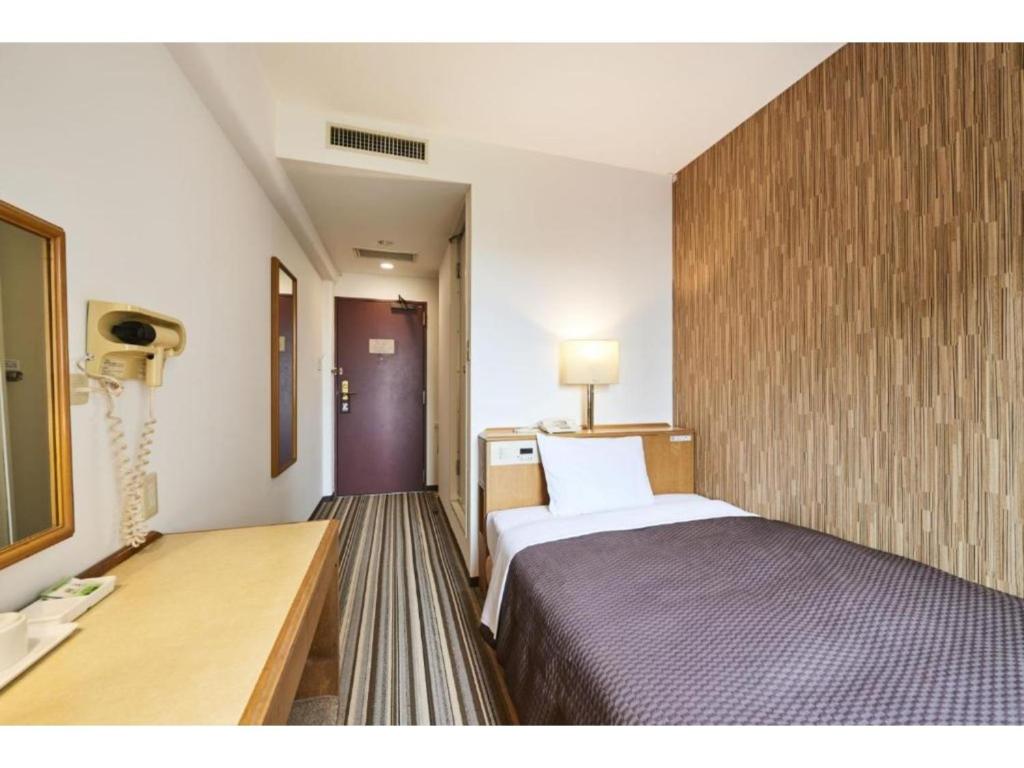 a hotel room with a bed and a desk at Urayasu Sun Hotel - Vacation STAY 32992v in Urayasu