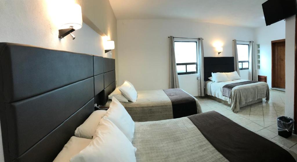 Postel nebo postele na pokoji v ubytování Hotel El Relicario