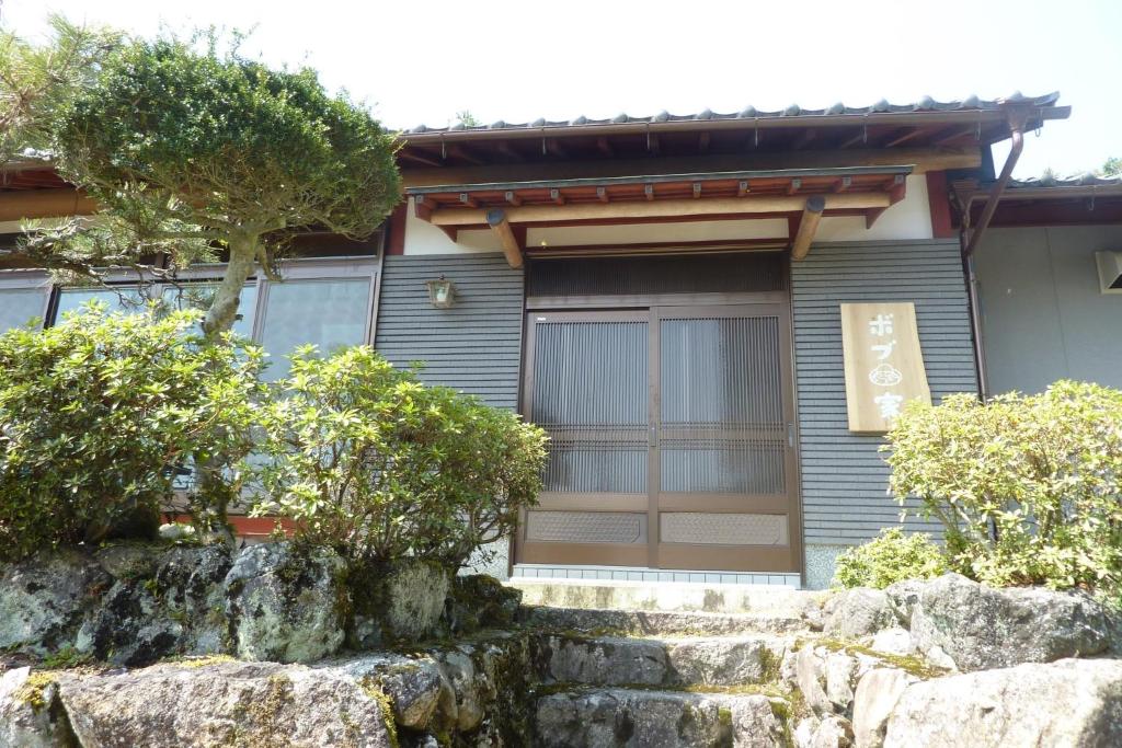 a house with a stone wall in front of it at Bob's house - Vacation STAY 42876v in Kameoka
