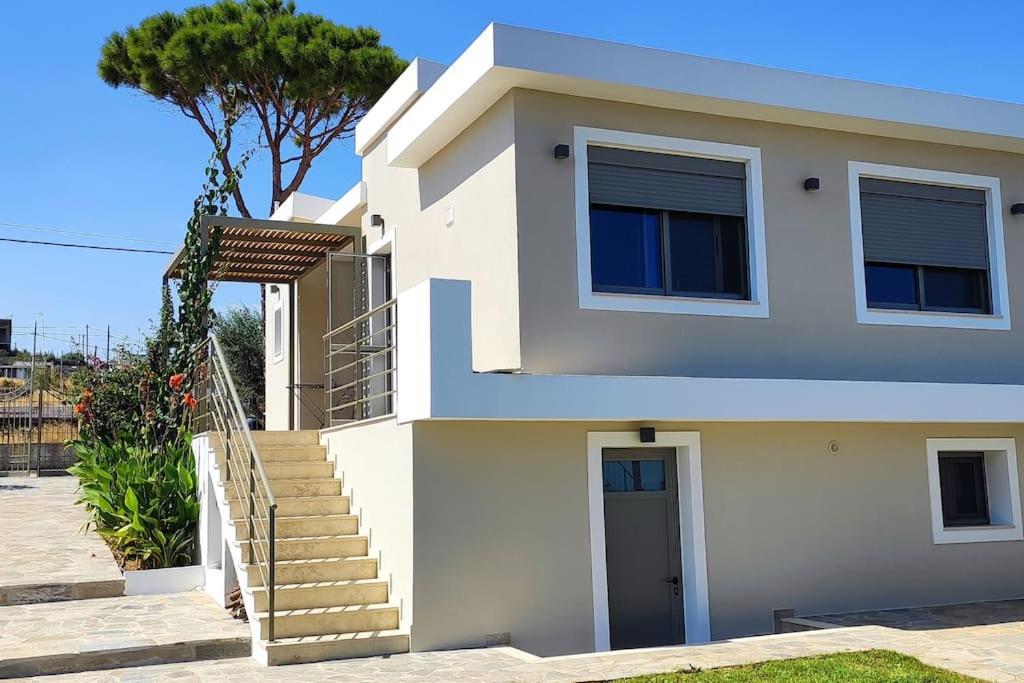 a white house with stairs and a tree at ΜΟΝΤΕΡΝΑ ΒΙΛΛΑ 2 ΕΠΙΠΕΔΩΝ-MODERN VILLA in Rafina