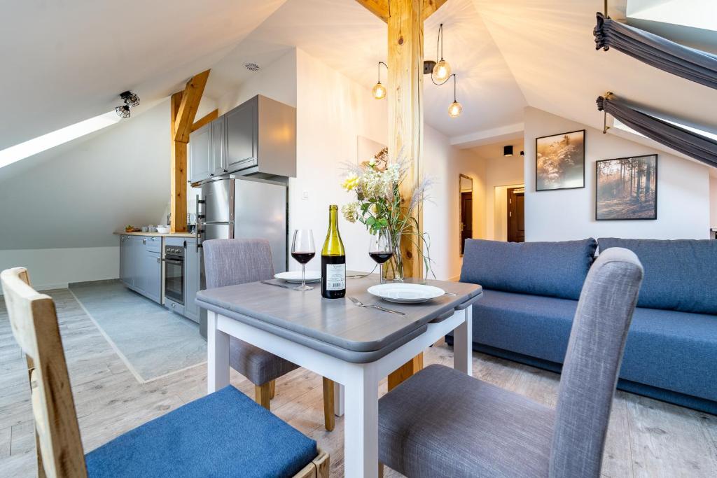 別爾斯科－比亞瓦的住宿－Apartamenty Nad Niwką，厨房以及带桌子和沙发的客厅。