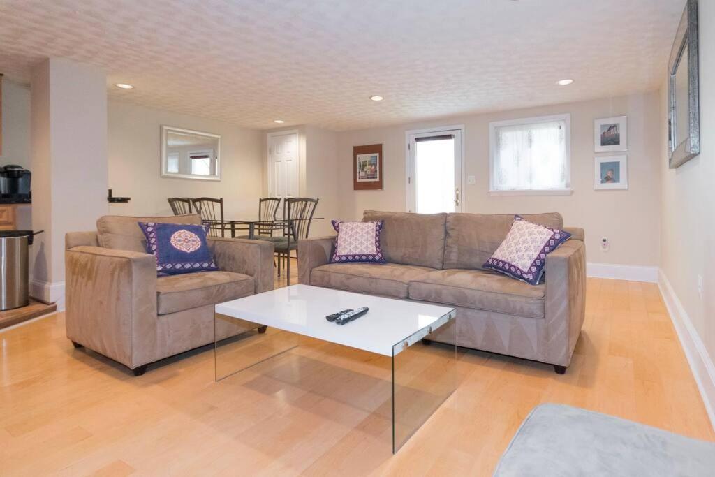 a living room with two couches and a coffee table at Cathedral Charmer--2 BR English Basement, with Garden Access in Washington