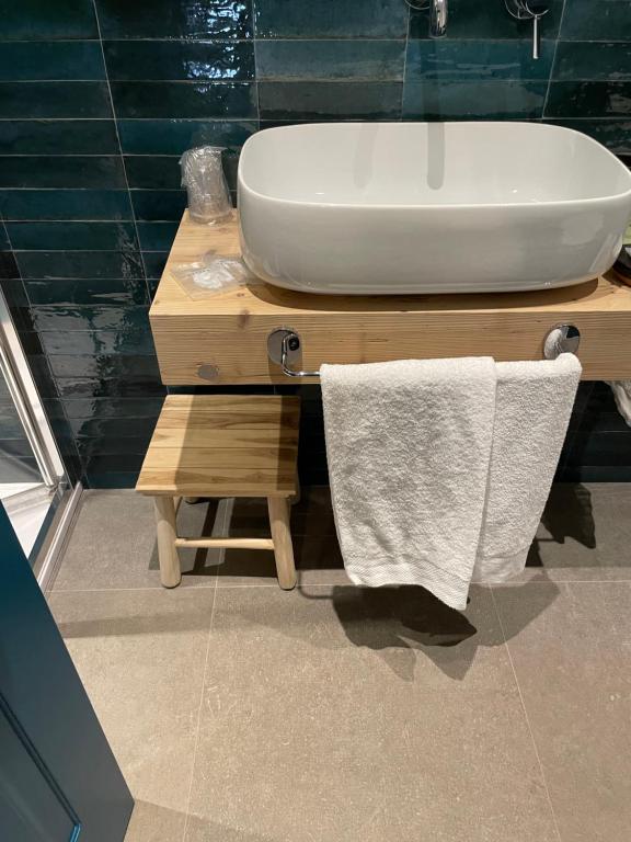 a bathroom with a white sink and a white towel at Isolotto Guest House in Porto Ercole